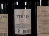 several bottles of wine are lined up on a shelf