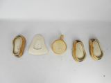 four pairs of shoes are lined up in a row on a white surface