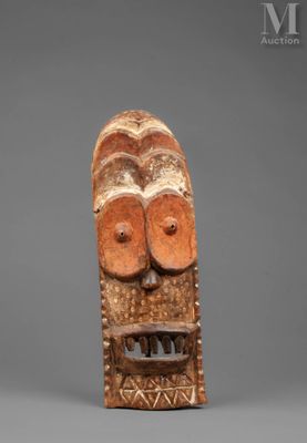 a wooden mask with two eyes and a mouth