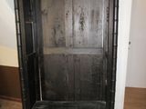une armoire en bois noir dans une pièce avec du parquet