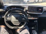 a man sitting in the driver ' s seat of a car