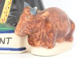 a figurine of a bull and a book on a table