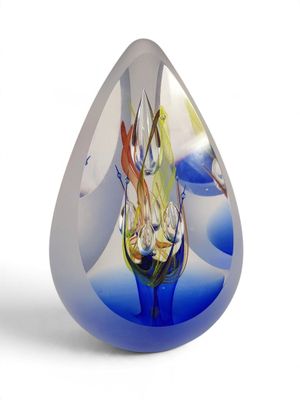 a glass sculpture of a horse inside of a blue tear