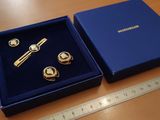 a blue box with a pair of cuff watches and a pair of cuff watches