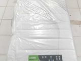 a mattress that is wrapped in plastic on the floor
