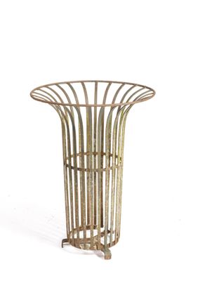 a metal basket that is sitting on a white surface