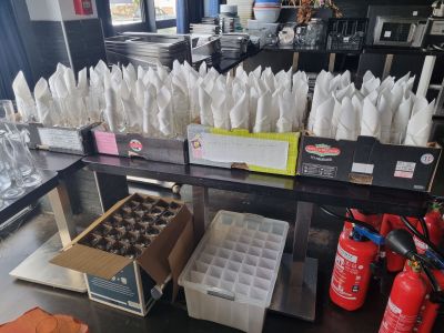 many bags of food sitting on a table in a store