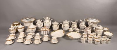 a lot of white and gold china on display