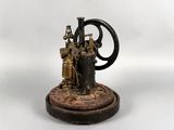 a small statue of a steam engine on a table