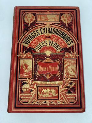 un vieux livre à la couverture rouge et aux lettres dorées