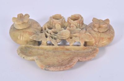 a small carved object on a white surface