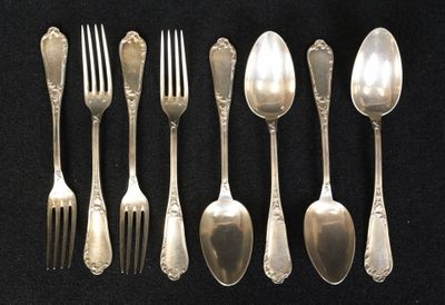 six spoons and six forks are lined up on a black surface