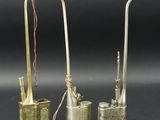 three different types of brass objects on a black surface