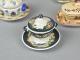 many different types of tea cups and saucers on the table