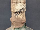 a very old bottle that has a lot of stuff on it