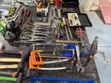 many tools that are on a workbench in the garage