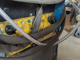 a machine that is sitting on the ground with hoses