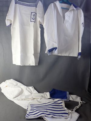 two shirts and a pair of pants hanging on a wall