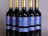 six bottles of red wine are lined up in a row
