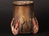 a brown vase with two hands sticking out of it