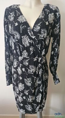 the dress is black and white with white flowers on it