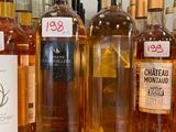several bottles of wine are lined up on a counter