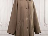 an image of a coat with a fur collar on a mannequin stand