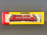 a close up of a red train in a box on a table