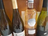 several bottles of wine are lined up on a wooden crate