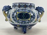 a blue and white vase with two lions on it
