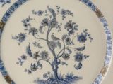 a blue and white plate with a tree on it