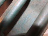 a close up view of a metal chair with rust on it