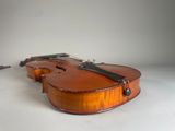 an old violin sitting on top of a white surface