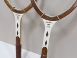 two tennis rackets that are sitting on a table