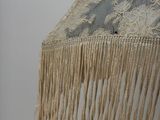 an umbrella with a lace fringe hanging from it