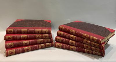 several red books stacked on top of each other on a table