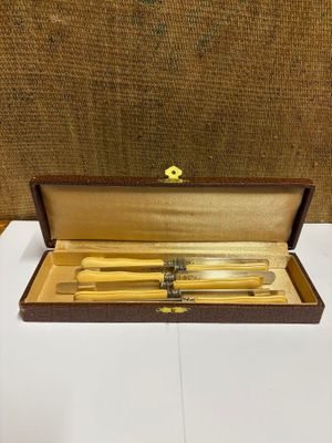 a wooden box with two knives and a fork in it