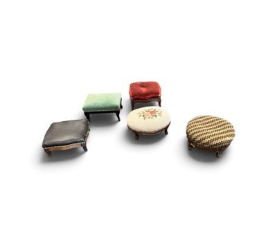 four small stools and a small ottoman on a white surface
