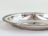 a silver bowl and a silver cup on a white table