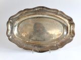 an old silver plate with a picture of a man on it