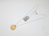 a close up of a necklace with a tag attached to it