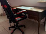 a desk with a chair and a computer on it