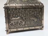 a metal box with a design on it on a white surface