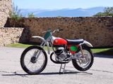 a red and green motorcycle parked in a parking lot