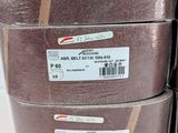 several rolls of brown cloth are stacked on top of each other