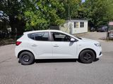 a white car that is parked on the side of the road