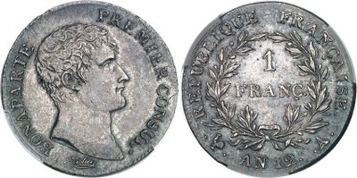 a close up of a coin with a man ' s face on it