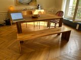 a wooden table with a laptop on it in a room