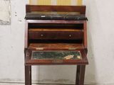 a small wooden desk with a drawer on top of it