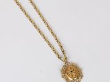a gold plated necklace with a medallion on a chain